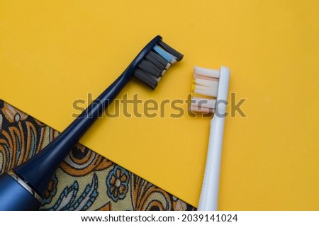 two electric toothbrushes white and blue, oral hygiene