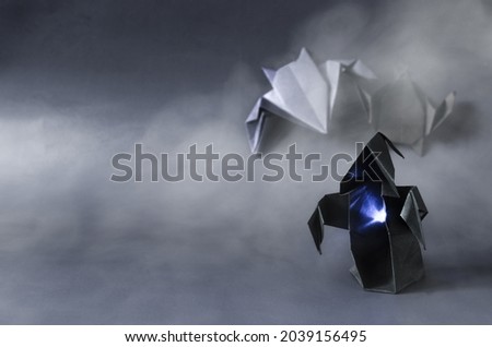 The figure of a dark ghost in the fog on a dark background is the place for the text. Dark paper ghost for the Halloween holiday
