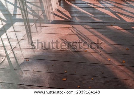 part of transparent certain with light and shadow on the wood strip ground Royalty-Free Stock Photo #2039164148