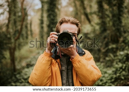 Photographer man taking a photo outdoor traveling
