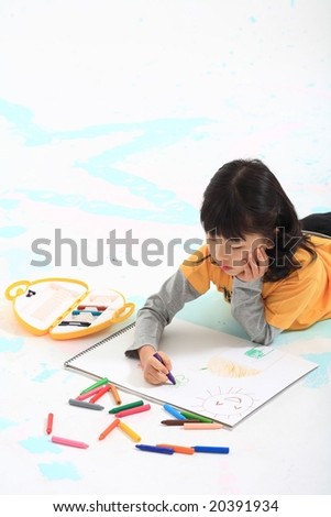 Lovely Happy Girl and Colorful Crayons - drawing and painting a pretty picture with a cute little kid on a white sketchbook