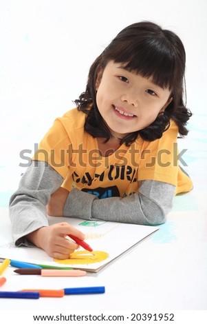 Lovely Girl and Colorful Crayons - drawing and painting a pretty picture with a cute little kid on a white sketchbook