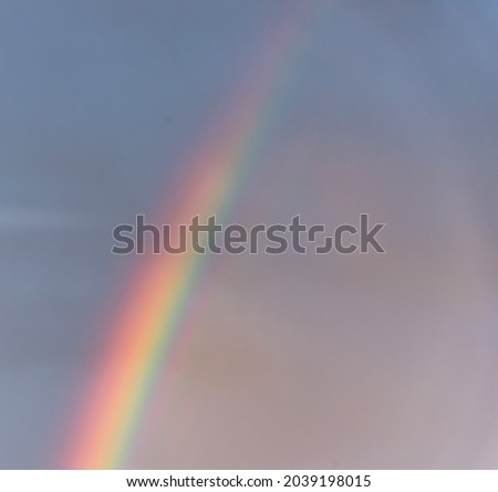 Bright Rainbow on a Sunny and Cloudy Morning