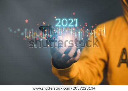 financial management plan concept stock market chart Businessmen show an increasing number of virtual holograms every year. 2021 via smartphone
