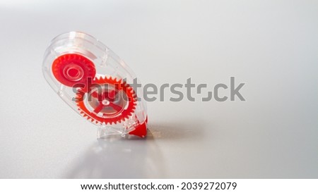 Correction tape for correcting text in the form of a convenient red pencil on a gray background. Royalty-Free Stock Photo #2039272079