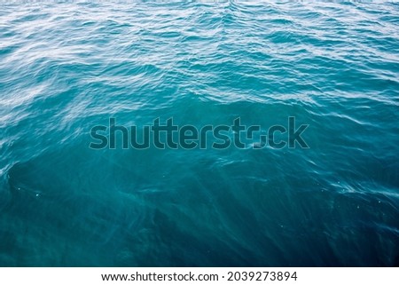 Turquoise wavy sea background. Sea texture. Abstract sea background photo. Maritime, tourism, travel theme.