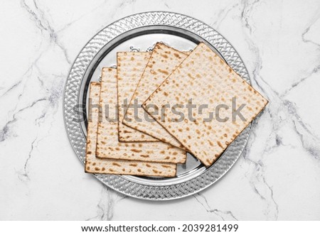 Passover Seder plate with matzo on white background