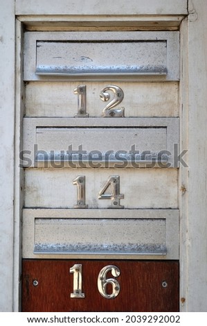 Close Up of Metal Mail Boxes with Numbers  '12-14 and 16'