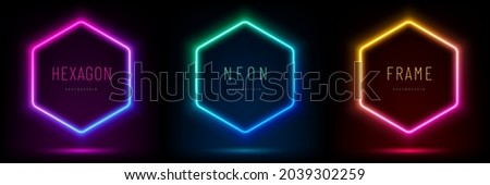 Set of pink-blue, red-purple, green illuminate hexagon frame design. Abstract cosmic vibrant color geometric backdrop. Collection of glowing neon lighting on dark background with copy space. Top view. Royalty-Free Stock Photo #2039302259