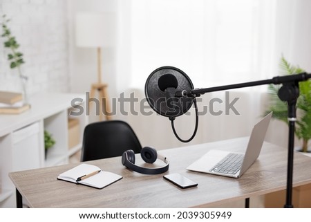 podcast and blogging concept - modern workplace with computer and microphone at radio station office