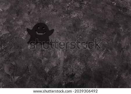 Halloween black ghost shape sticker on grey background. Halloween card, copy space