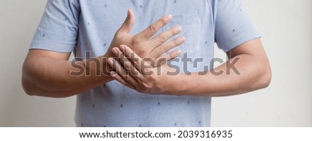 man hand with numbness and pain in the palm of the hand has pain and tingling in the nerve endings. which is a side effect of Guillain-Barre Syndrome after vaccination against COVID-19.