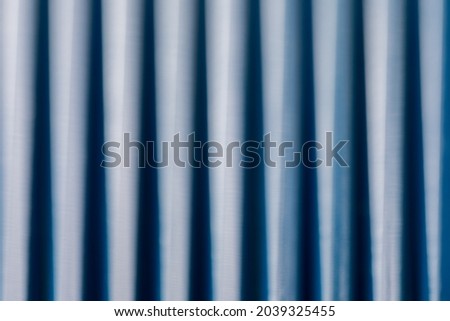 Abstract background of blurry focus on blue sticks in dark and light tone.