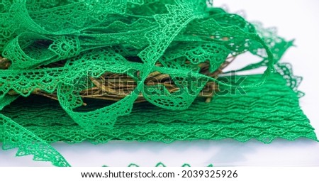 Green lace ribbon. Thick elastic lace ribbon with floral trim for design, craftwork and gift wrapping