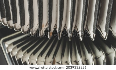 Close Up Photo of a Vintage Accordion on a  Mirror on a Black Colored Background.