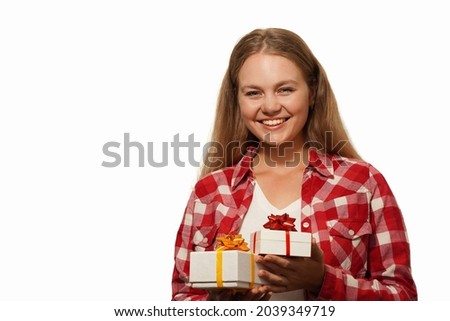   Smiling beautiful blonde young woman holding a gift boxes isolated over white background. Happy birthday, Christmas, Valentine's Day concept. Place for text.                                