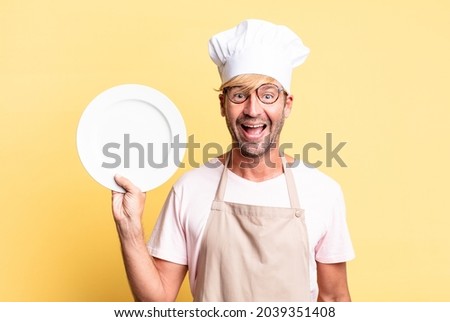 blonde handsome chef  adult man with an empty dish