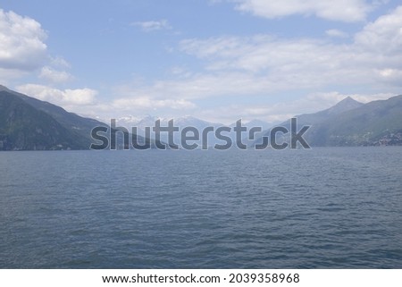 Panoramic view of Lake Como on a cloudy day with the Alps in the