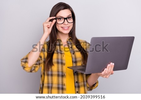 Photo of young business woman happy positive smile agent use laptop project isolated over grey color background