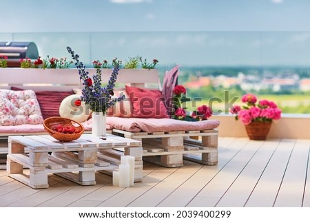 cute, cozy pallet furniture with colorful pillows at summer patio, lounge outdoor space Royalty-Free Stock Photo #2039400299