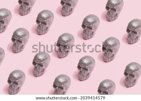 Sparkling skulls scary minimal pattern arrangement. Baby pink creepy background