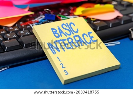 Conceptual caption Basic Interface. Concept meaning boundary across which two independent systems meet and act Multiple Assorted Collection Office Stationery Photo Placed Over Table