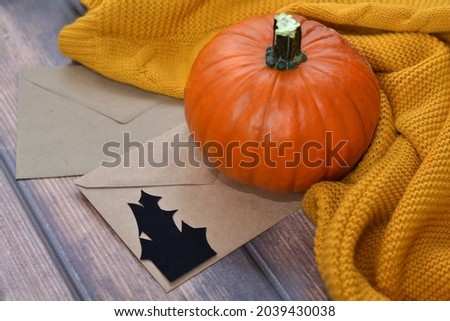 Halloween orange pumpkin and envelopes with silhouette of ghost. Happy halloween. 