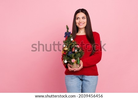 Photo of cool brunette lady hold little tree look empty space wear red pullover isolated on pink color background