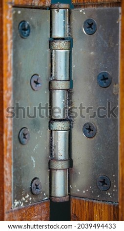 Metal Hinge holes on a wooden surface