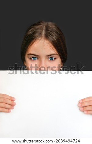 Girl with blue eyes close up with white blank sheet