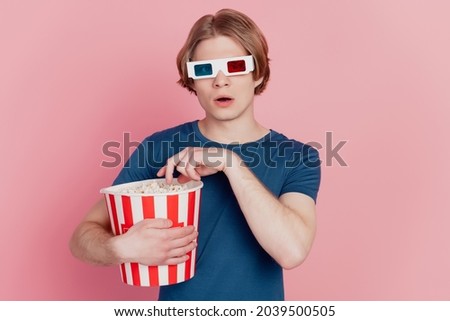 Photo of young guy hold popcorn paper box wear 3d glasses watch movie isolated pink color background