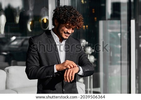 Indian businessman waiting for his team of programmers. Royalty-Free Stock Photo #2039506364