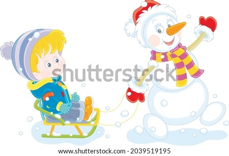 Funny snowman friendly smiling, waving its hand in greeting and sledding a happy little boy on a snowy winter day, vector cartoon illustration isolated on a white background