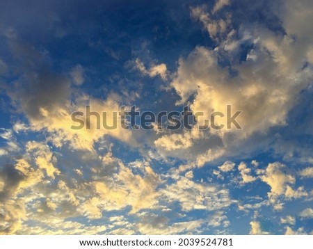 Natural background. Blue sky with clouds at sunset. Close-up.