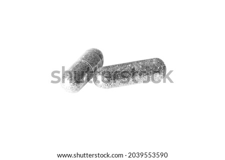 tablets capsules with glitter on a white background