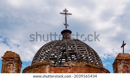 Open dome construction. Metal orthodox cross. An abandoned church in Tatarstan, Russia. Ruins of an old abandoned brick church.