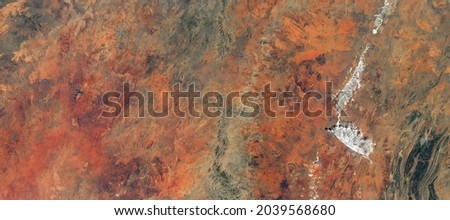 Aerial top view of desert land, satellite photo of Earth surface, map for abstract texture background. Nature pattern like painting, landscape topography. Elements of this image furnished by NASA. 