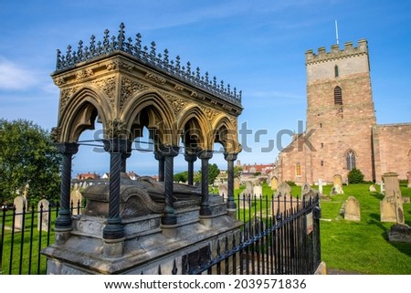 Tomb of Grace Darling in the churchyard of St. Aidans Church in Bamburgh, Northumberland, UK. She was the daughter of a lighthouse keeper and saved 9 people from a shipwreck in 1838. Royalty-Free Stock Photo #2039571836