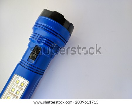 Photo of a blue LED flashlight.  Isolated white background.