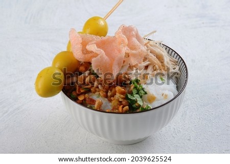 Bubur ayam or Indonesian rice porridge served with shredded chicken Royalty-Free Stock Photo #2039625524
