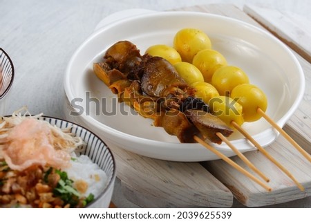 Bubur ayam or Indonesian rice porridge served with shredded chicken