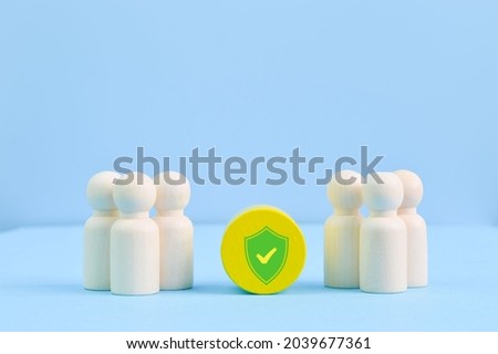 Group of workers and shield. Medical insurance, labor safety and health protection Royalty-Free Stock Photo #2039677361