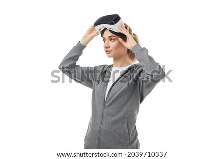 Young woman adjusting VR goggles