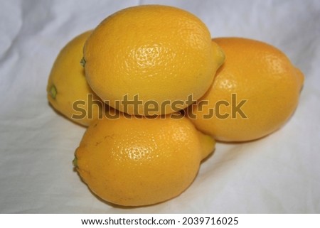 Some fresh yellow lemons on a table.