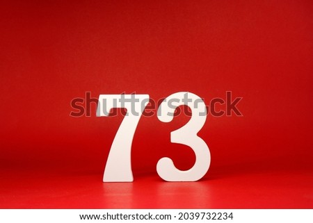 Seventy Three ( 73 ) white number wooden Isolated Red Background with Copy Space - New promotion 73% Percentage   Business finance or birthday Concept - advertise banner picture online with copy space