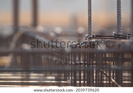 Construction work in progress with reinforcement framework of deformed steel bars and wires Royalty-Free Stock Photo #2039739620