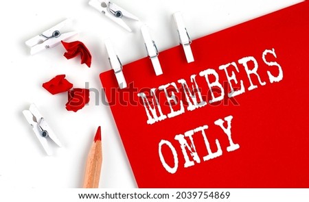 MEMBERS ONLY text on the red paper with office tools on the white background