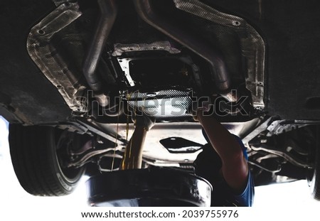 Automatic transmission flushes and fluid replacements service in garage service shop. Royalty-Free Stock Photo #2039755976