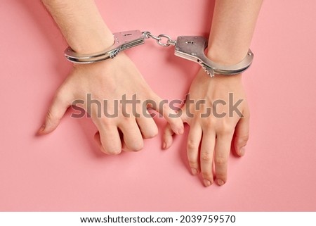 Male and female hands in handcuffs. Love forever. Prenuptial agreement, duties of love couple. Royalty-Free Stock Photo #2039759570