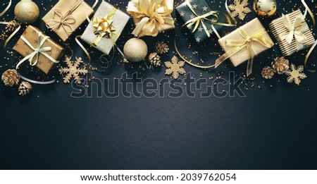 Christmas golden decoration with gift boxes on dark background. Template for greeting card